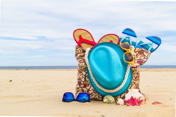Accessory bag full sunbathers beach background