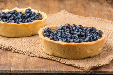 fresh blueberries homemade tart on a wooden desk