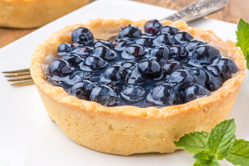 fresh blueberries homemade tart on a wooden desk
