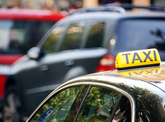 Yellow taxi sign on the roof of a taxi car. Yellow cab sign on the roof of the cab car. Stock photo.