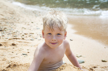 Child playing in the sand on the beach
