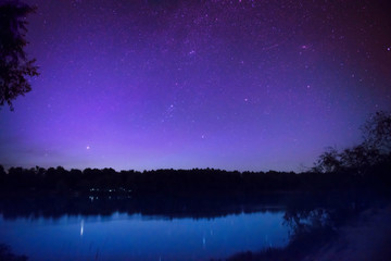 Fototapeta premium Beautiful night sky with many stars on a lake