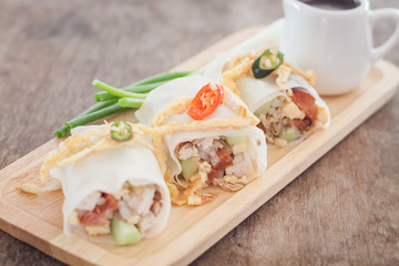Fresh spring rolls on wooden table