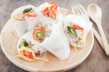 Fresh spring rolls on wooden table