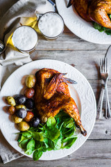 Roasted half chicken with potatoes and spinach
