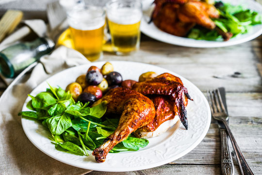 Roasted half chicken with potatoes and spinach