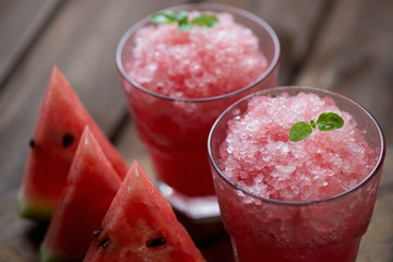 Two glasses with watermelon granita, close-up, studio shot