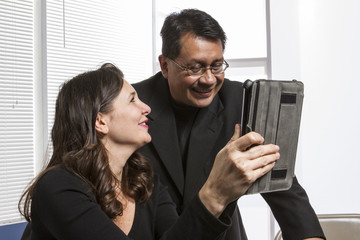 Man and a woman using a tablet