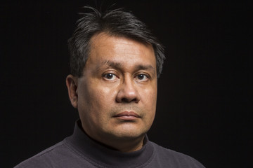 Studio portrait of a serious Hispanic man