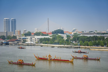 Landscape of Thai's king palace with goldent guard ship on the front.