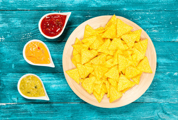 Plate of nachos with different dips