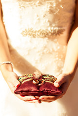 Bride is holding a ring 