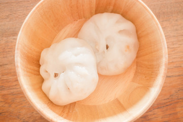 Steamed dumpling stuff on wooden bowl