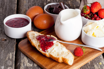 Croissant with strawberry jam and fresh berries