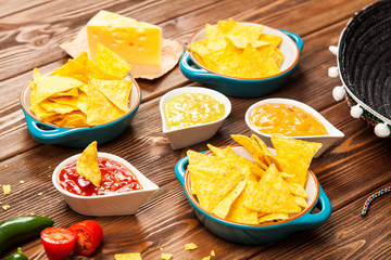 Plate of nachos with different dips