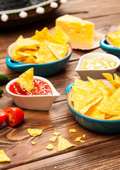 Plate of nachos with different dips