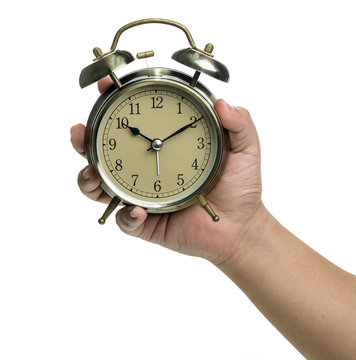 Hand holding a clock on white background