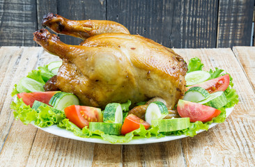 Roast chicken on wooden vintage board