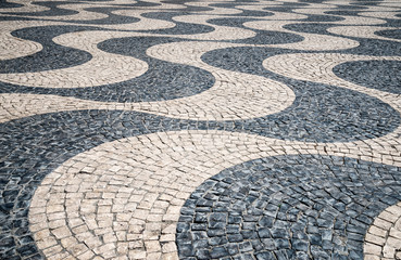 Typical portuguese cobblestone hand-made pavement in Portugal, L