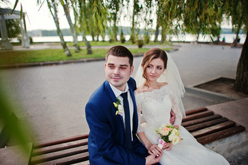 wedding couple sitting on the bench