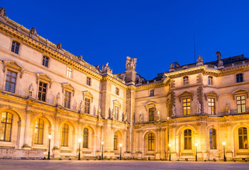 Fototapeta na wymiar Paris - June 18: Louvre museum at dusk on June 18, 2014 in Paris
