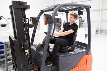 Male Fork Lift Truck Driver Working In Factory