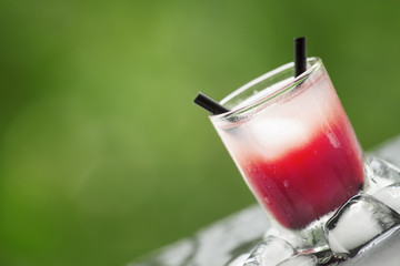 Frozen pink cocktail with ice on the sun deck on a summer day, s