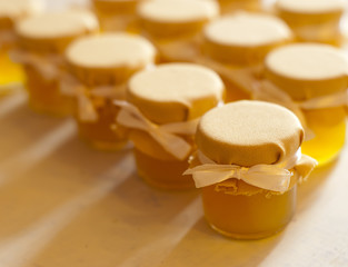 Jar of honey on white table jam confiture marmalade pozzy  make conserve preserve