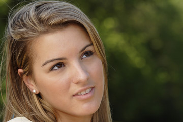 Fototapeta premium A young woman looking up in thought.