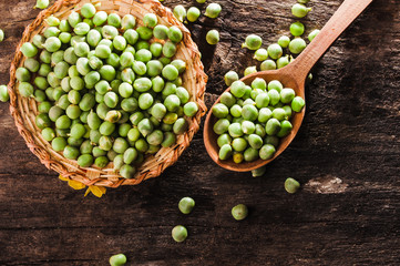 Basket of fresh green peas on the table
