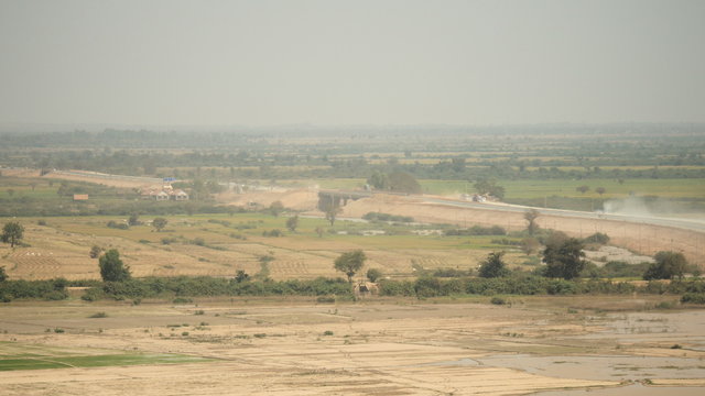 Distance view on dusty road with traffic