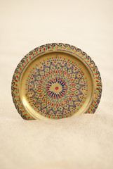 Round copper brass tray salver in desert sand
