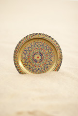 Round copper brass tray salver in desert sand