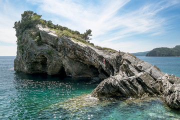 Naklejka premium The beach and the cliffs on the island of St. Nicholas in Budva,