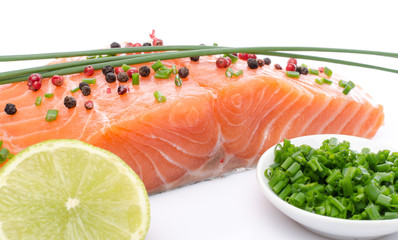 Fresh raw salmon fillet with herbs, lemon and spice