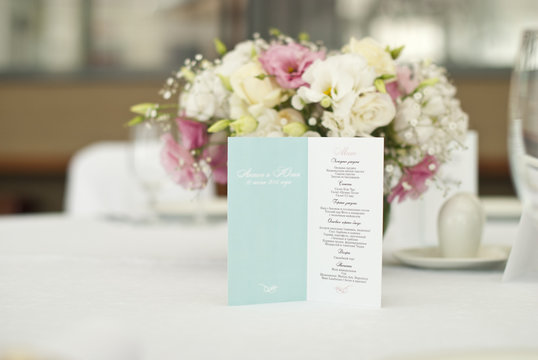 Menu card with beautiful flowers on table in wedding day 
