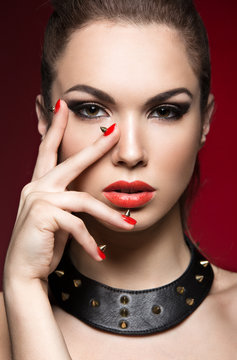 Beautiful woman in gothic style, evening makeup and red nails