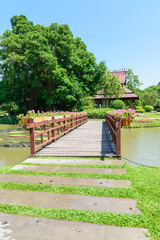 A wooden bridge over a canal in the park of Thailand.