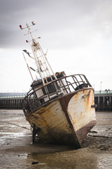 Fototapeta premium Old boat on the beach in low tide in Inhambane, Mozambique 