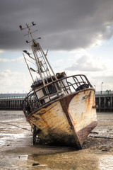 Fototapeta premium Old boat on the beach in low tide in Inhambane, Mozambique 