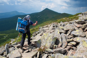 Tourist with large backpack  on mountain