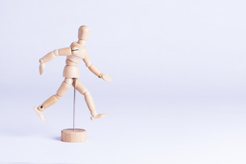 wooden mannekin on white background