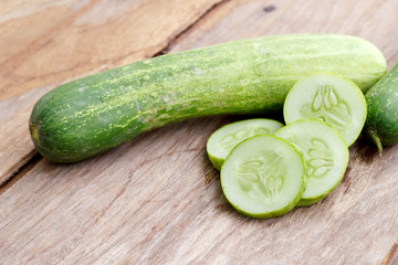 Cucumber isolated on wood background.