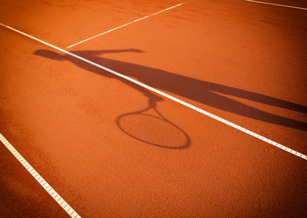 shadow of a tennis player in action on a tennis court © Željko Radojko