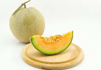 slice japan melon isolated on wood plate