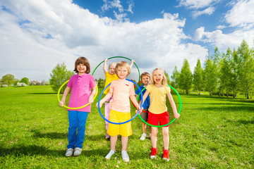 Kids hold hula hoops during exercising activity