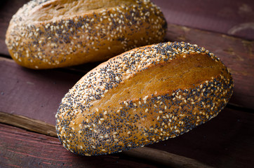 Freshly baked small breads with sesame and poppy seeds