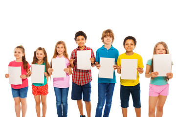 Many kids stand with blank paper sheets in line