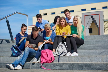 Fototapeta premium students outside sitting on steps