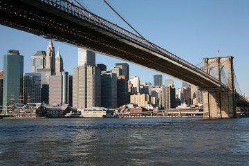 Fototapeta na wymiar Manhattan skyline and Brooklyn Bridge over East River
